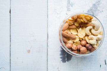Homemade granola with nuts and seeds in glass jar for healthy breakfast
