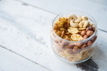 Homemade granola with nuts and seeds in glass jar for healthy breakfast