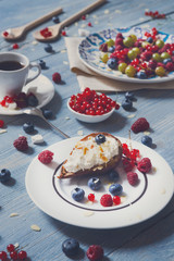 Breakfast with baked pea and berries at blue rustic wood