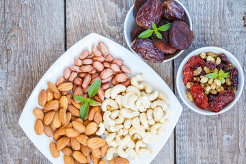Different types of nuts and dried fruits.  Healthy dietary snack, dried fruit, nuts, top view.