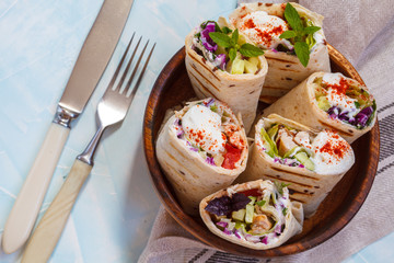 Grill chicken with fresh vegetables salad burrito wraps.