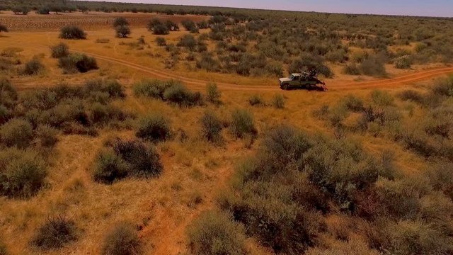 The SUV Is Driving Through The Savanna Among The Wild Beasts Of Africa.