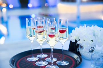 Waiter served champagne glasses on a tray in a fine dining restaurant