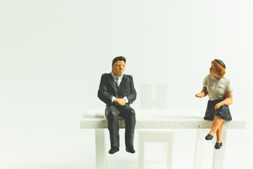 Miniature people business concept sitting on chair with a space for text