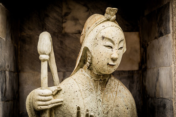 Fototapeta na wymiar old statue in public in Thailand with dramatic tone
