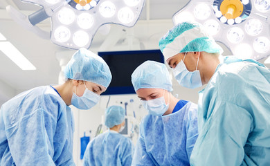 group of surgeons in operating room at hospital