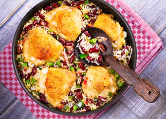 Chicken with Rice, Beans, Bacon and Green Pepper in Pan. View from above, top studio shot