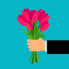 Hand holding pink tulip flowers bouquet