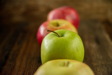 Fresh red apples with green leaves on wooden table. On wooden background. Free space for text . Top view