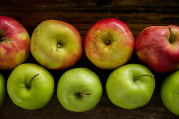 Fresh red apples with green leaves on wooden table. On wooden background. Free space for text . Top view