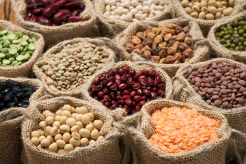 Multicolor dired legumes in burlap sack, Different dry bean for eating healthy