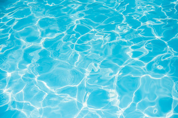 Fototapeta na wymiar Blue and bright ripple water and surface in swimming pool , Beautiful motion gentle wave in pool