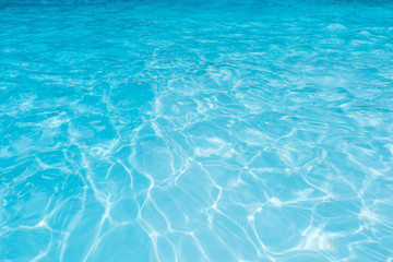 Fototapeta na wymiar Blue water surface in swimming pool for background