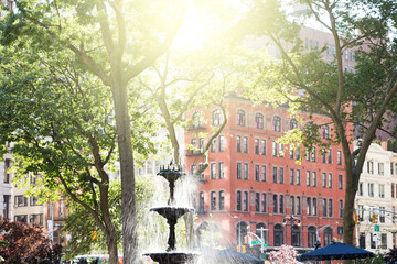 Summer scene with fountain and historic buildings in Madison Square Park in Manhattan, New York City