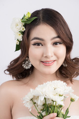 Obraz na płótnie Canvas Beautiful asian woman bride on grey background. Closeup portraits with a professional makeup