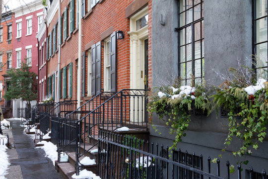 Historic buildings and snowy sidewalks of Grove Street in the Greenwich Village neighborhood of Manhattan, New York City