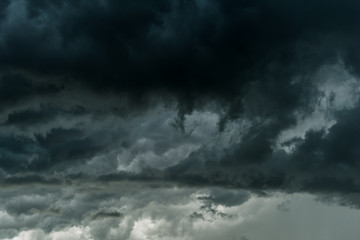 Obraz premium Dark sky and black clouds before rainy, Dramatic black cloud and thunderstorm high contrast