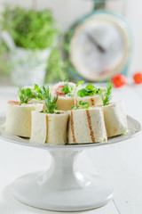 Closeup of tortilla with vegetables and cheese on white table