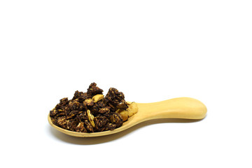 Chocolate Granola in the wooden spoon on white background.