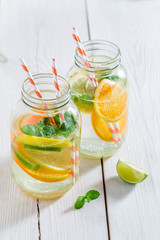 Closeup of soda in bottle with berries and mint leaves