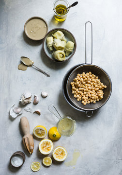 Ingredients for hummus, including chickpeas, garlic, lemon, and artichokes