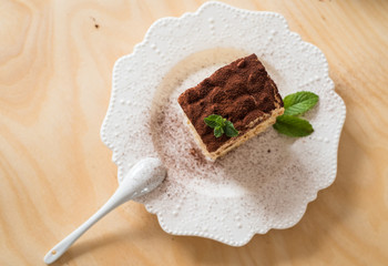 Tiramisu cake on a white porcelain plate