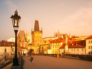Charles Bridge with Lesser Town Bridge Tower and Prague Castle on background. Sunny morning in Prague, Czech Republic.