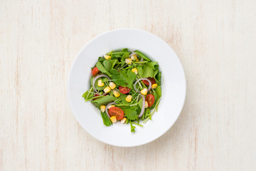 Homemade fresh green vegetable salad on table.