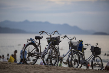Fototapeta na wymiar Bicycle on the beach on a blue sky