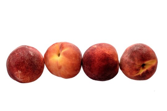 A few ripe peaches isolated on a white background