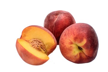 Fototapeta na wymiar Peaches whole and sliced halves with a bone isolated on white background
