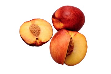 Peaches whole and sliced halves with a bone isolated on white background