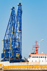 Big cargo ship in sea port terminal with cranes in Balchik, Bulgaria