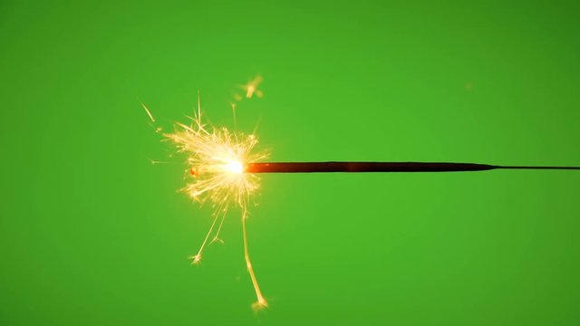party sparkler burning on green background