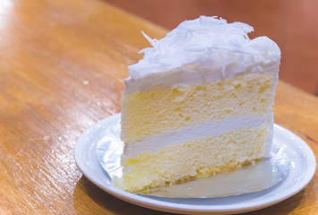 Coconut cake on wooden table background in coffee bakery shop Thailand