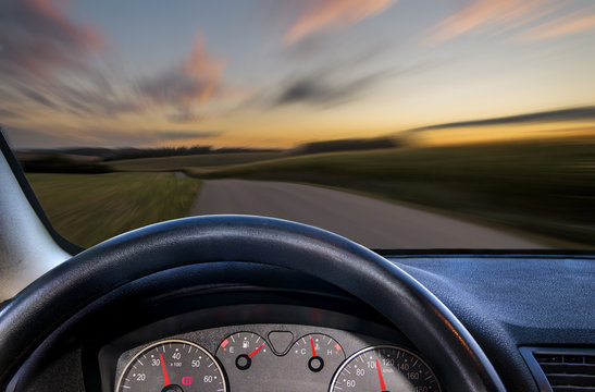 A View From Behind The Steering Wheel Of A Car