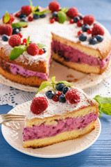 Delicious homemade cake with berry cheese cream.