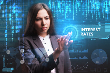 The concept of business, technology, the Internet and the network. A young entrepreneur working on a virtual screen of the future and sees the inscription: Interest rates