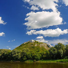 Cloudy sky above the river at the mountain.