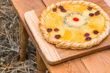 Fruit pizza with pineapple, orange, kiwi, cherry