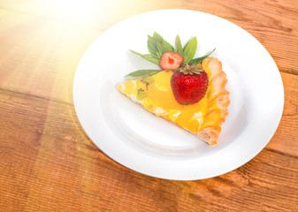 Slice of fruit pizza with strawberries and mint