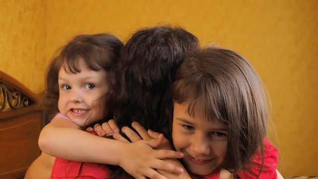 Emotions of children hugging mother. Daughters hug Mom.
