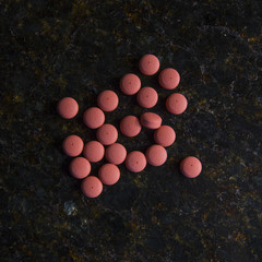 Human with pills in the palm of the hand.