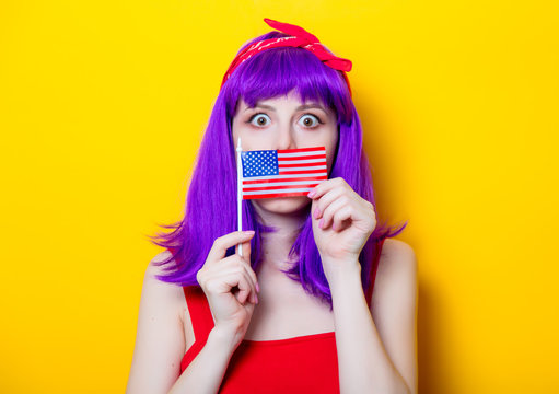 girl with purple color hair holding USA flag