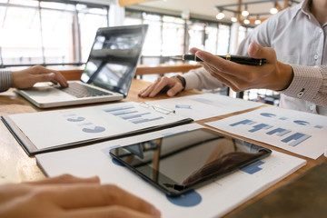 Business man analysis data document with accountant calculating about fee tax at a office