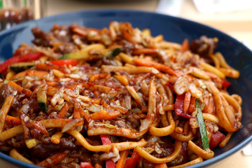 Noodles with meat and various vegetables - Asian fusion food. Selective focus.