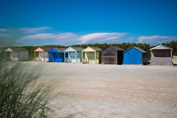 Fototapeta na wymiar Traditional beach huts on fine golden sand at West Wittering Beach West Sussex England UK 