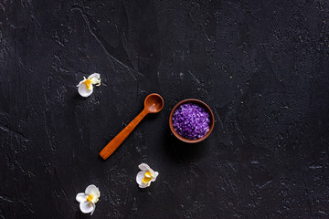 Lavender bath salt on balck stone table background top view copyspace