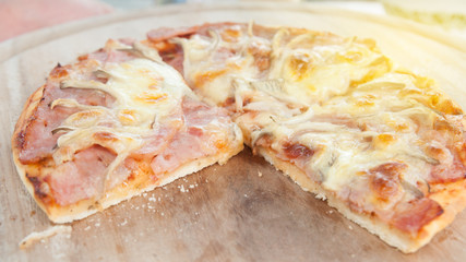 Homemade ham cheese lay on wooden tray.