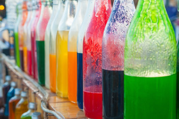 Colorful syrub in bottles for house interiors